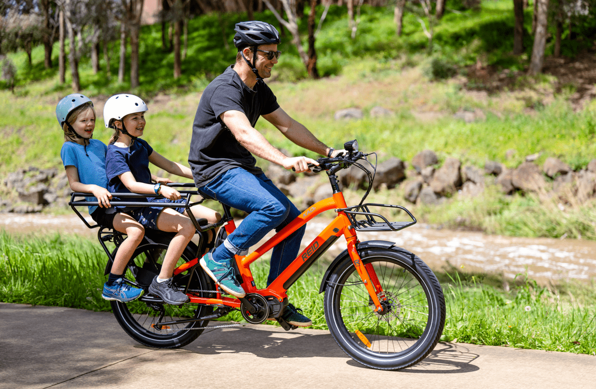 https://cdn.shopify.com/s/files/1/0885/3756/3504/files/kade-cargo-ebike-orange-reid-bikes-369630.png?v=1730603588
