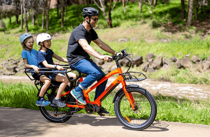 https://cdn.shopify.com/s/files/1/0885/3756/3504/files/kade-cargo-ebike-orange-reid-bikes-369630.png?v=1730603588